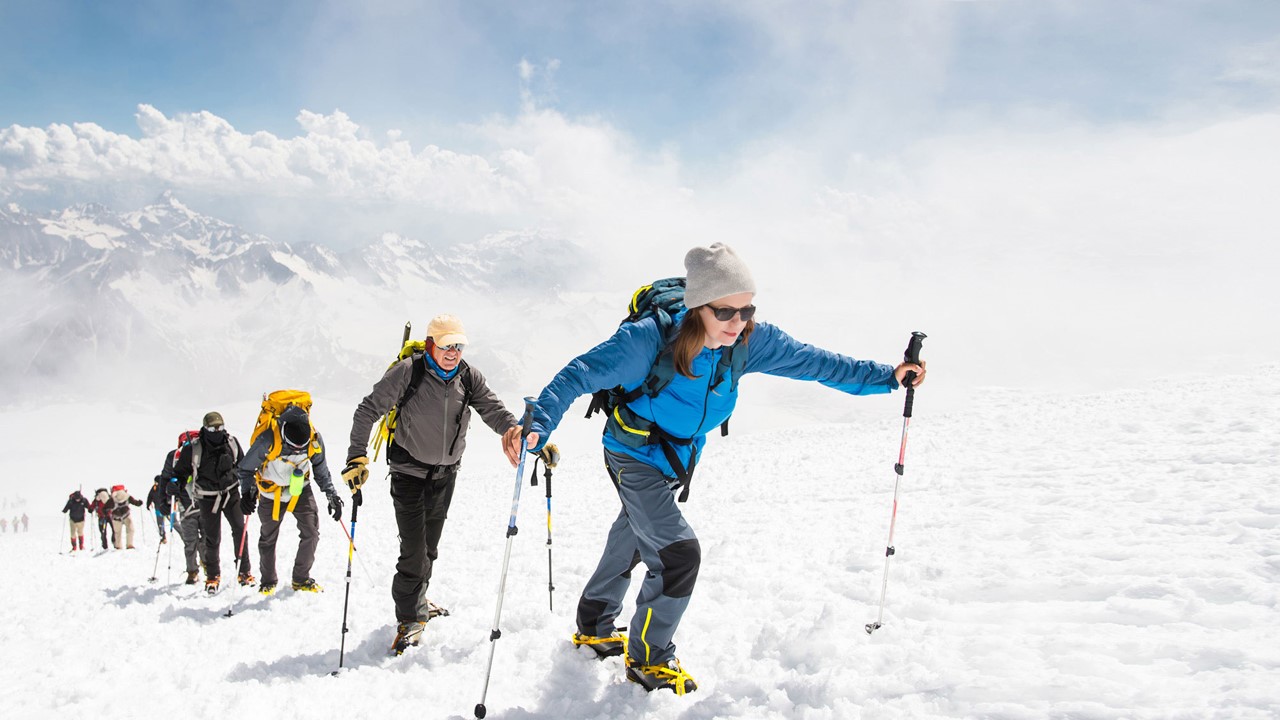 Group mountaineering on snowy slope.