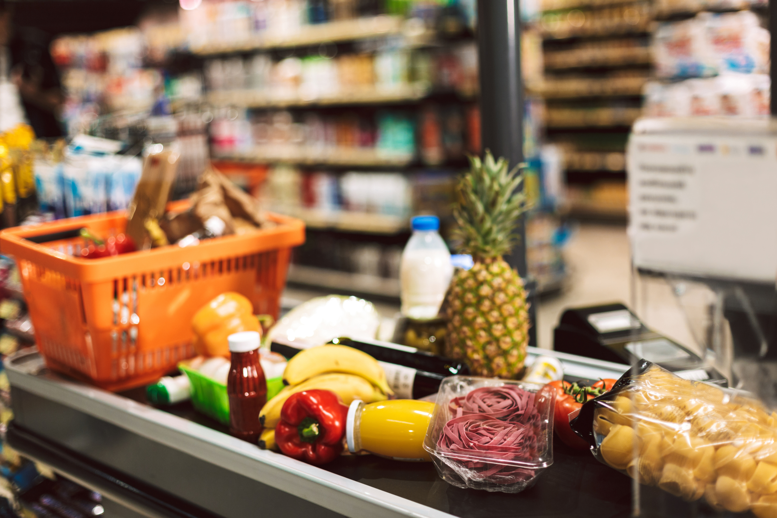 Groceries on supermarket checkout conveyor belt.