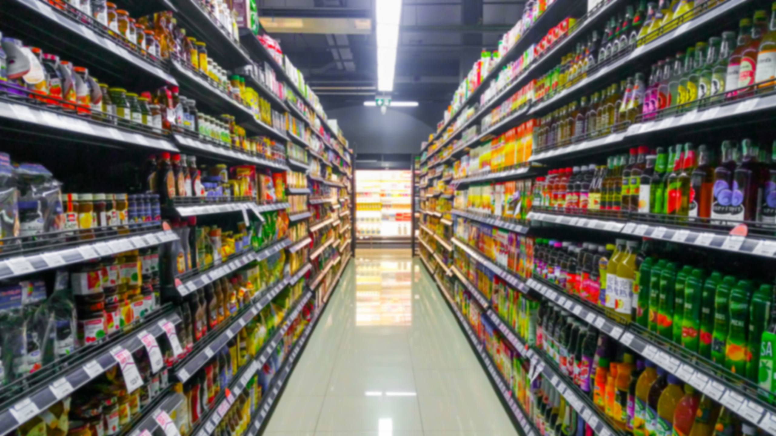 Supermarket aisle with various groceries.
