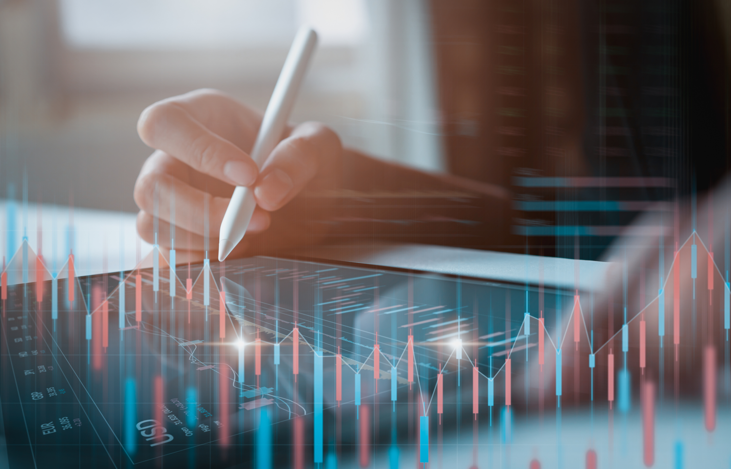 Person analysing financial graphs on digital screen.