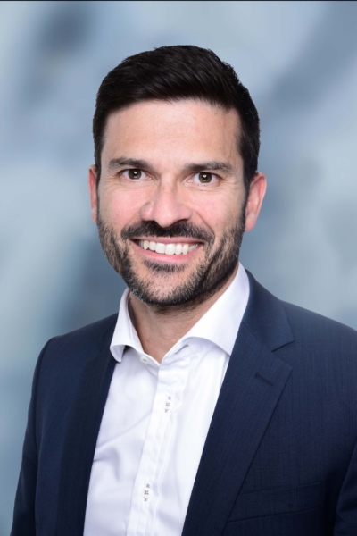 Smiling businessman in blue suit and white shirt