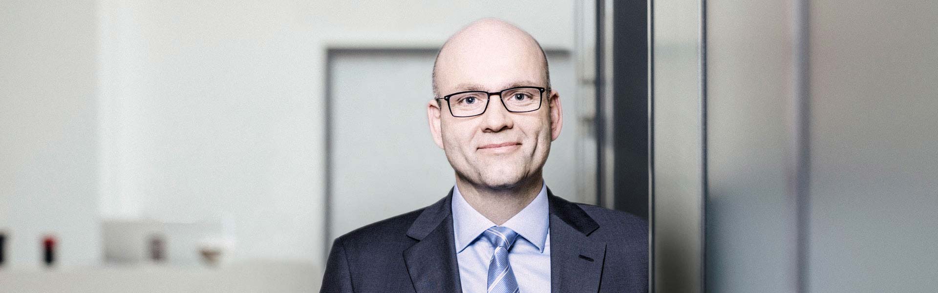 Professional man in suit with glasses smiling