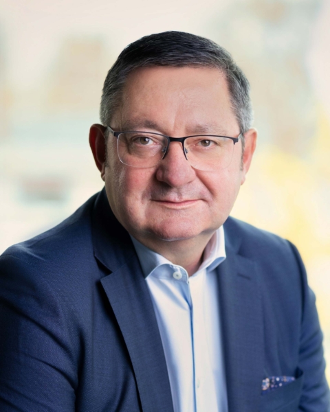 Professional man in suit smiling.