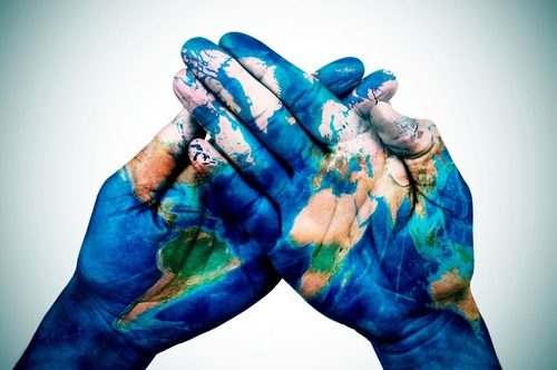 Hands painted with world map, environmental concept.