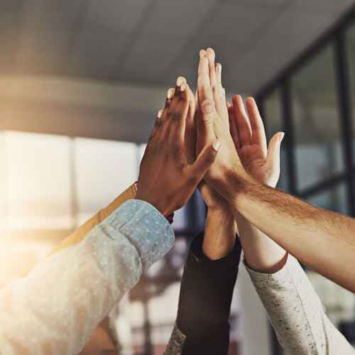 Team high five for success.