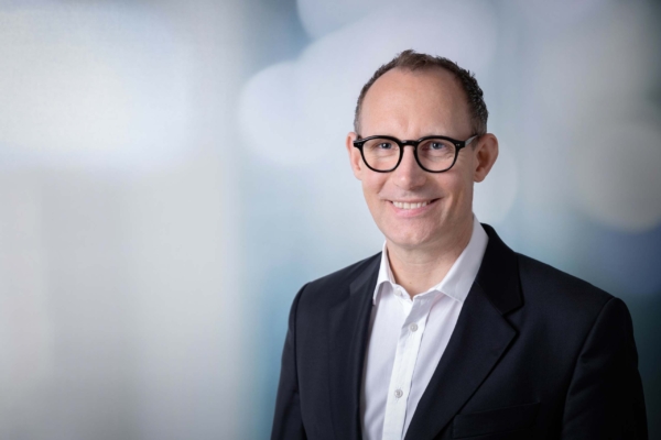 Smiling businessman in suit with glasses